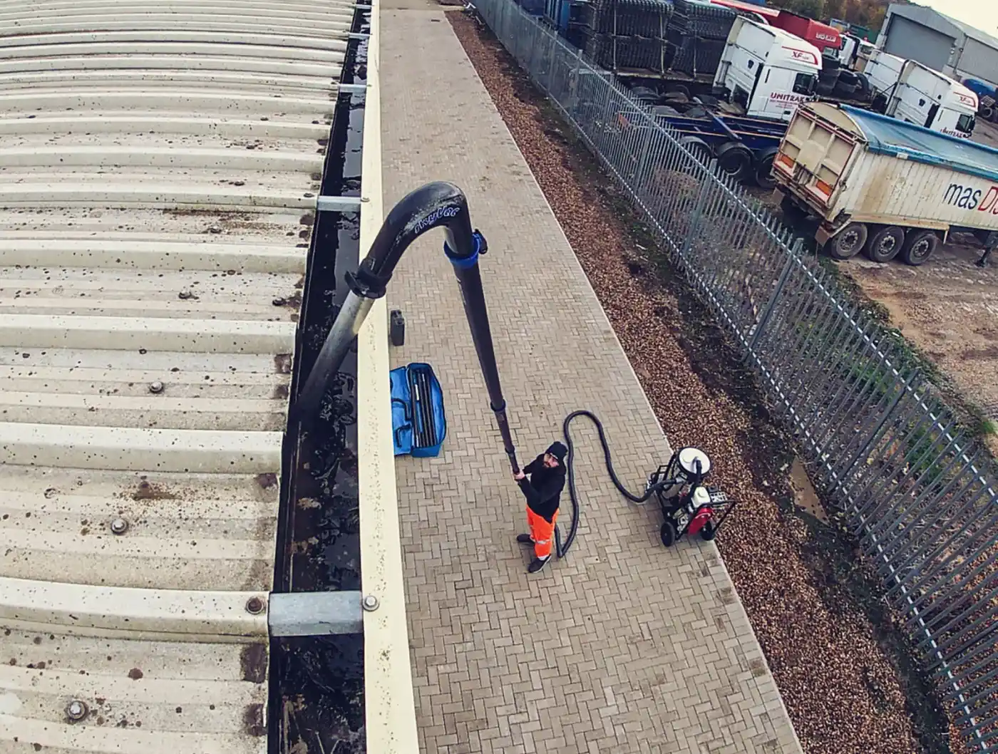 cleaning a gutter with a vacuum hose