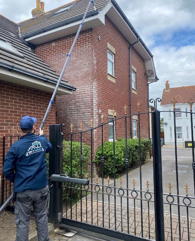 cleaning gutter with long pole